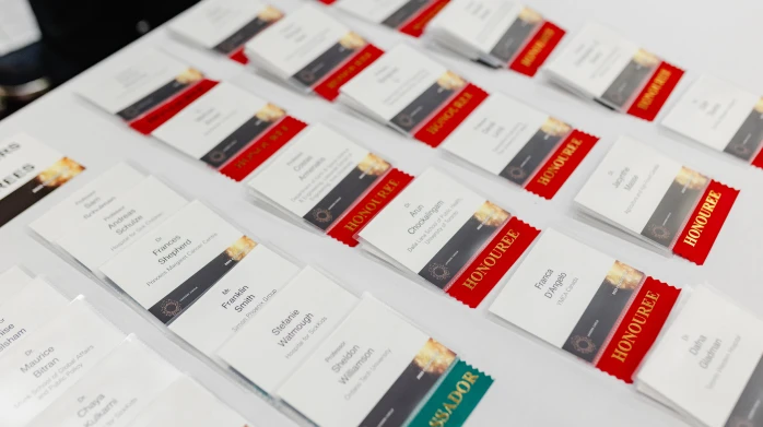 Rows of conference name badges laid out on a table