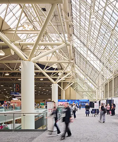 Attendees in the glass-roofed hall of the Metro Toronto Convention Centre