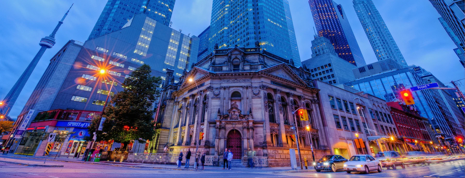 The Hockey Hall of Fame at dusk, surrounded by downtown Toronto towers