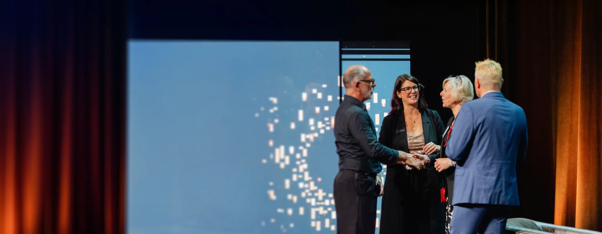 Two people on stage receiving an award
