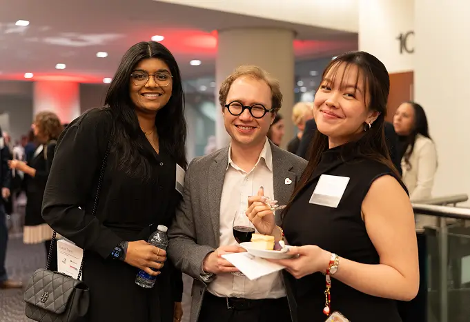 Three smiling guests at a networking event