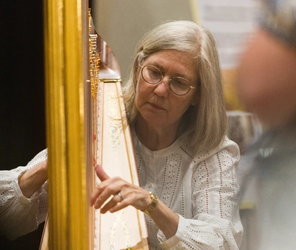 A woman playing a harp