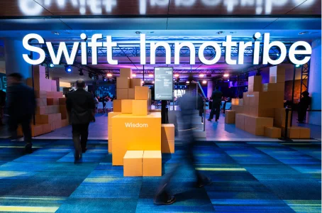 A crowd at a fintech event under a large Swift Innotribe sign