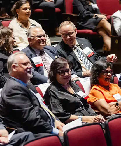 An audience seated in rows during a conference session
