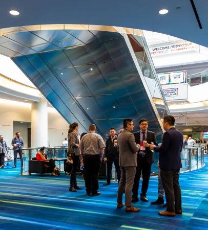 Attendees in a bright, modern convention centre lobby
