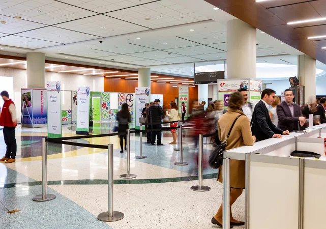 Visitors at poster displays in a convention centre hall