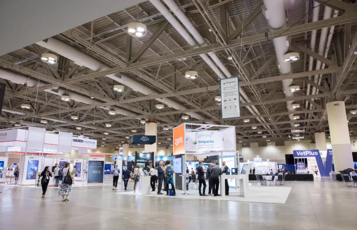 A large exhibition hall with booths and visitors