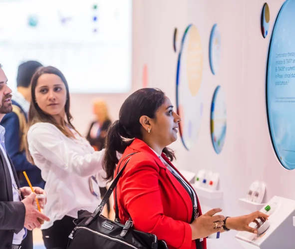 Two women using an interactive display at a technology exhibit