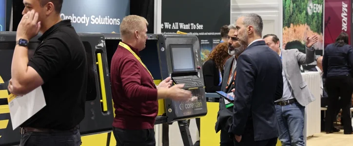 Exhibitors and visitors at booths in a technology trade show