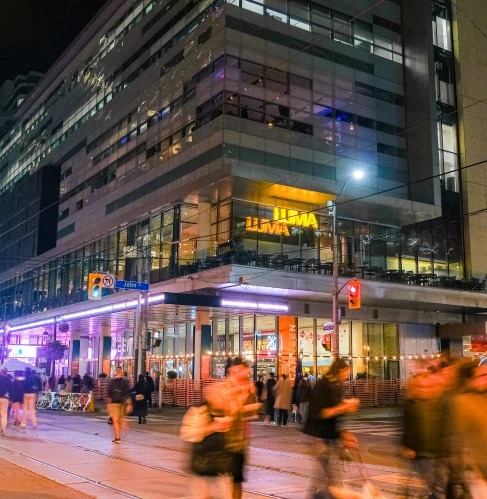 A lit-up street corner in downtown Toronto at night