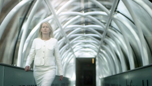 Dr. Ann Burchell walking through a glass-roofed walkway