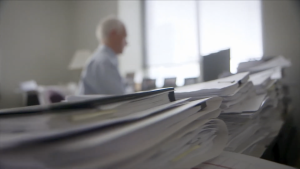 Dr. Cameron Mustard working at a desk in an office