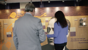 Dr. Maurice Bitran and Catherine Paisley looking at a museum exhibit