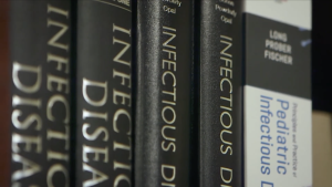 Books on infectious diseases on a shelf