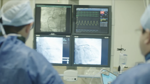 Medical staff in an operating room watching monitors