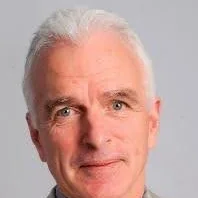Headshot of Dr. Cameron Mustard with short grey hair.