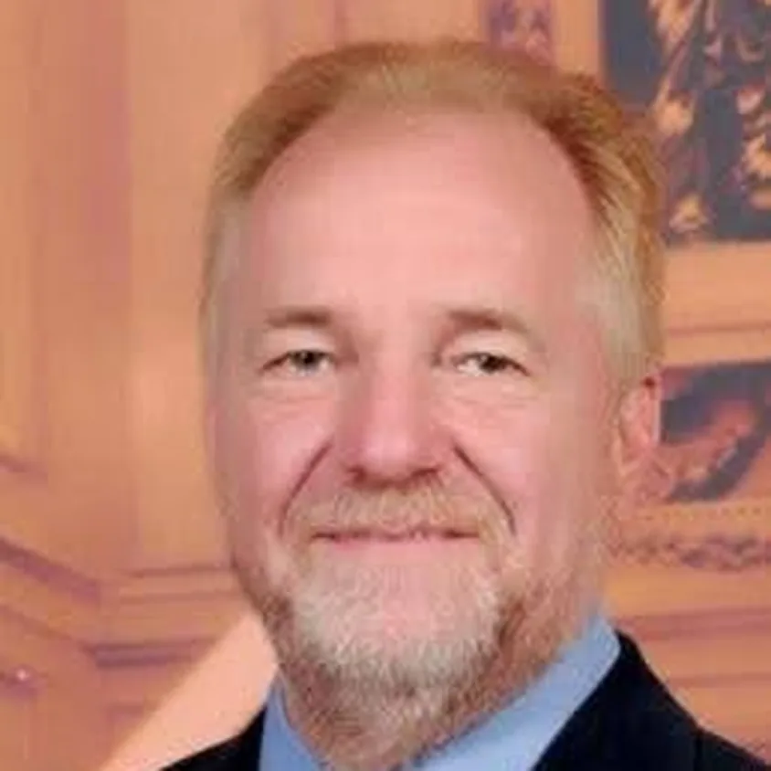 Portrait of Jim McArthur with light-coloured hair and a beard.