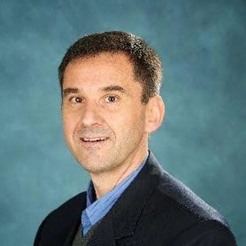 Professional headshot of Professor Kostas Plataniotis wearing a dark suit.