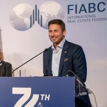 Speaker presenting at a podium during the Toronto Regional Real Estate Board FIABCI Congress.