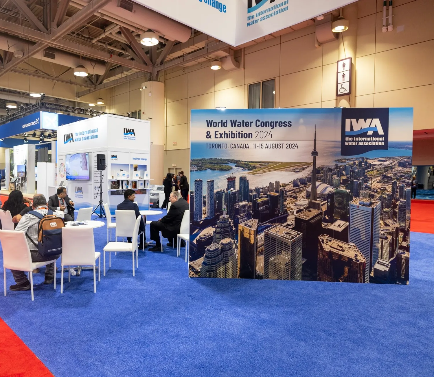 Delegates networking at the International Water Association exhibition booth during the 2024 World Water Congress in Toronto.